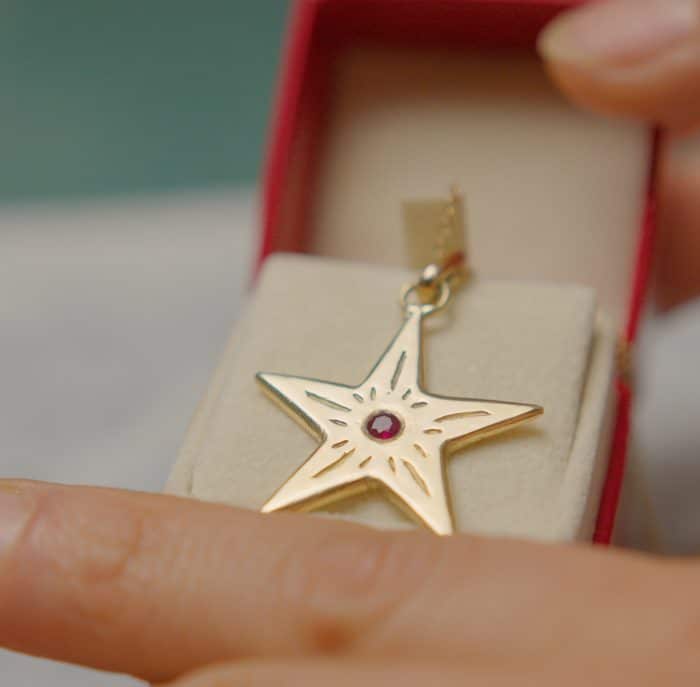 gold start pendant with ruby