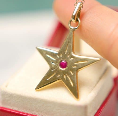 gold start pendant with ruby